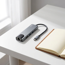 Hub USB-C Adaptador Multipuerto 5 en 1 - a clean white desk with a notebook